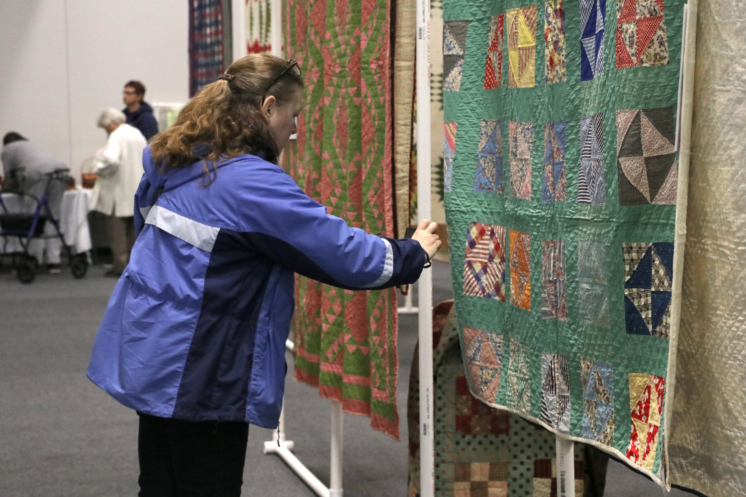Quilters enjoyed studying the work of others at the event.